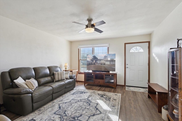 living room with dark hardwood / wood-style floors and ceiling fan