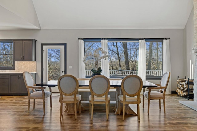 dining area with hardwood / wood-style flooring and lofted ceiling