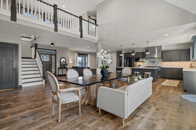 interior space with hardwood / wood-style floors and a high ceiling