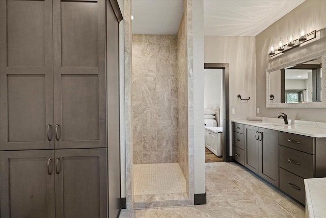 bathroom with vanity and tiled shower