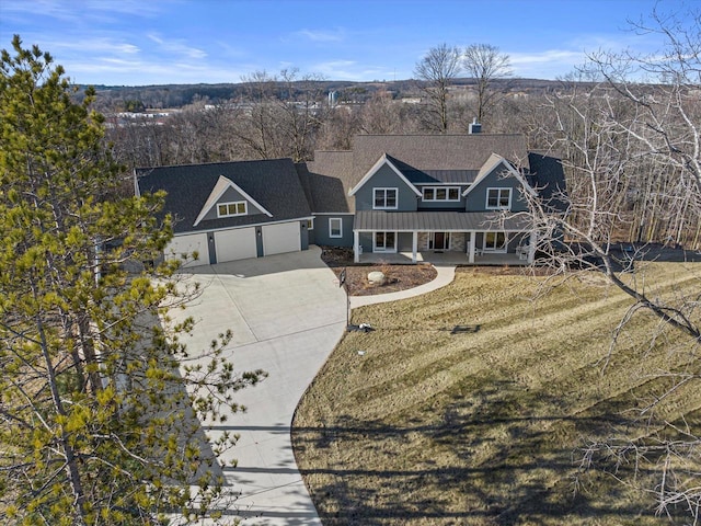 view of front of property with a front lawn, a garage, and covered porch