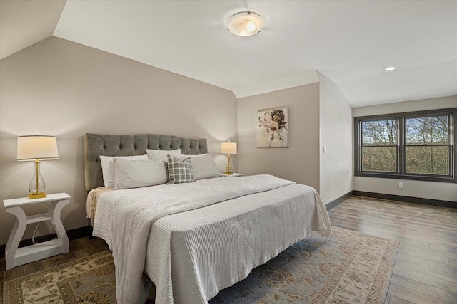 bedroom featuring vaulted ceiling and hardwood / wood-style floors