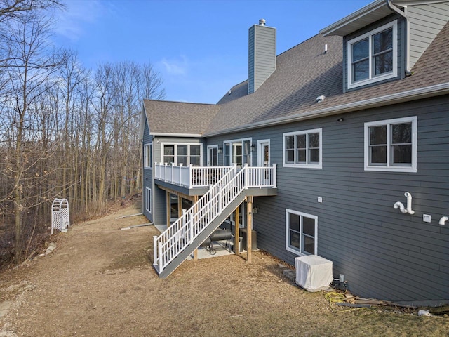 back of property with a wooden deck and cooling unit