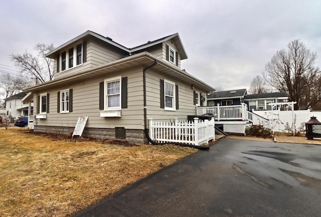 view of property exterior with a deck