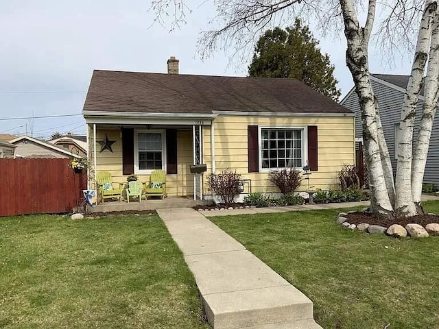 bungalow-style house with a front lawn and covered porch