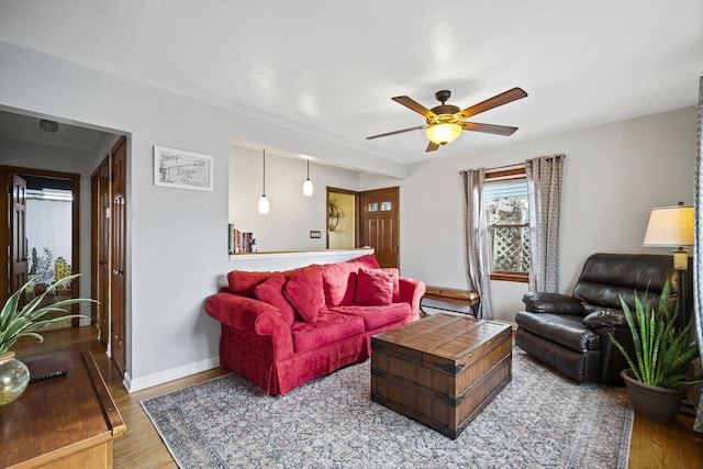 living room featuring hardwood / wood-style flooring and ceiling fan