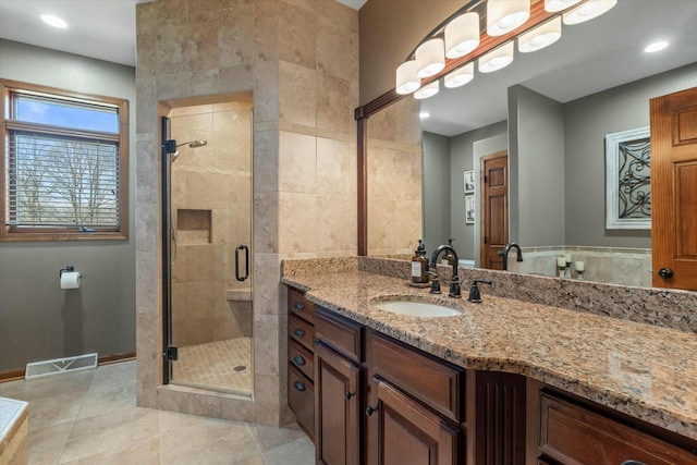 bathroom with vanity, an enclosed shower, and tile patterned flooring