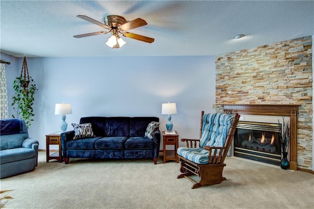 carpeted living room featuring ceiling fan and a textured ceiling