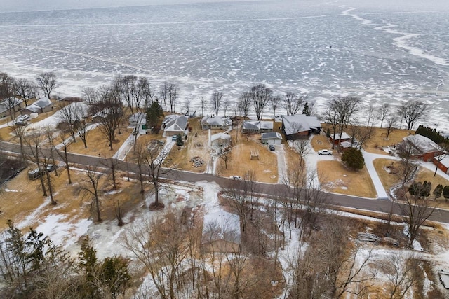 snowy aerial view with a water view