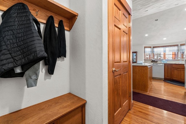 mudroom with light hardwood / wood-style flooring