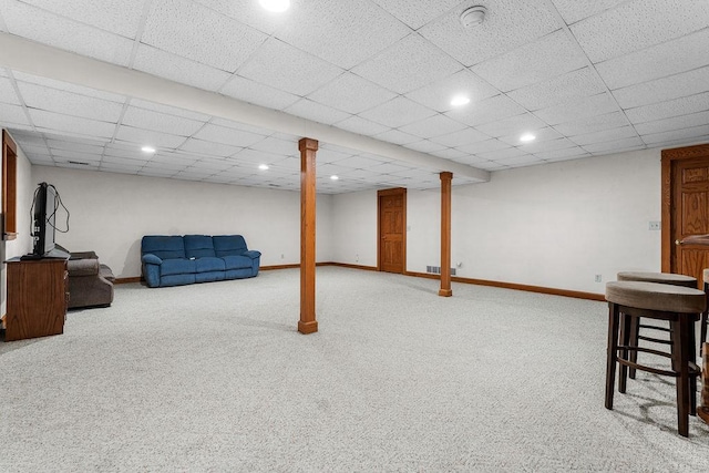 basement featuring carpet floors and a drop ceiling