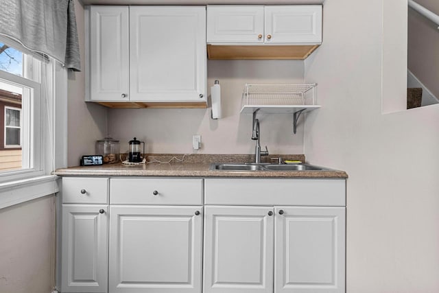 kitchen featuring white cabinetry and sink