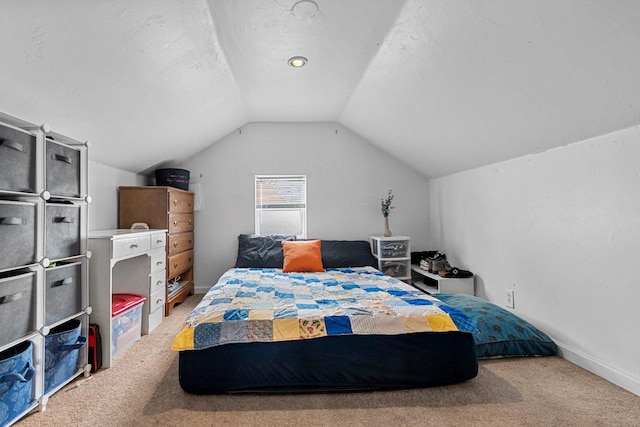 carpeted bedroom featuring lofted ceiling and a textured ceiling