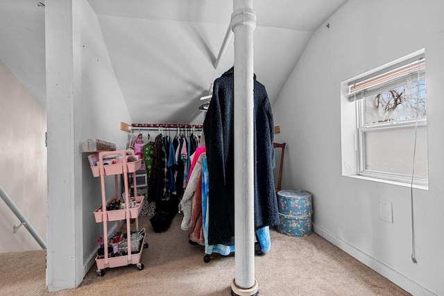 spacious closet with carpet flooring and vaulted ceiling