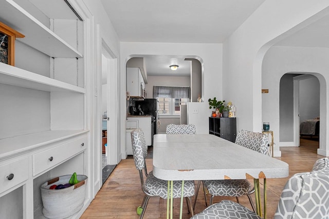 dining space with light hardwood / wood-style floors