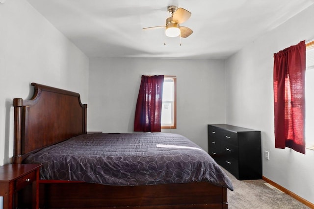 bedroom featuring light colored carpet and ceiling fan