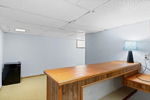 office with carpet floors and a paneled ceiling