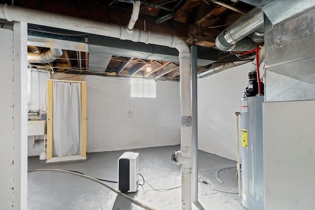 basement featuring gas water heater and sink