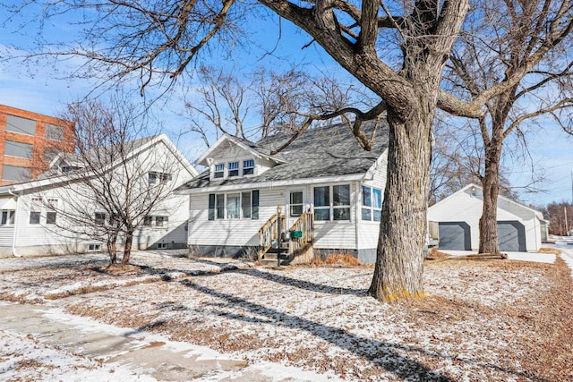 view of front of property with a garage and an outdoor structure