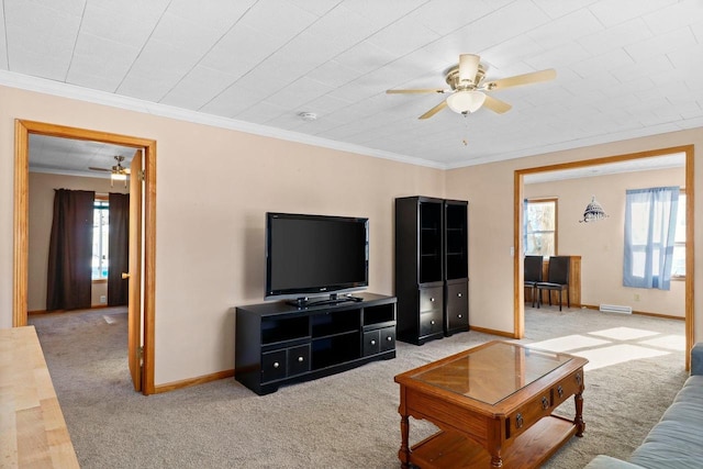 living room featuring ornamental molding, carpet floors, and ceiling fan