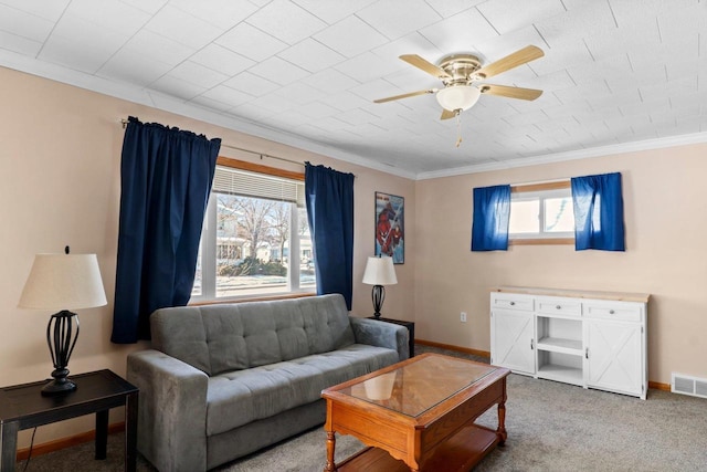 living room featuring ornamental molding, ceiling fan, and carpet