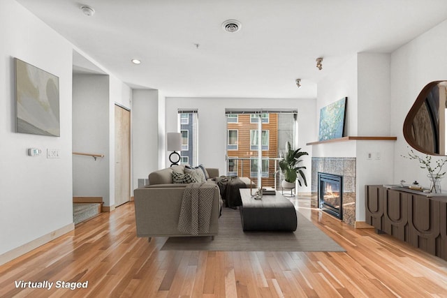 living room featuring a fireplace and light hardwood / wood-style floors