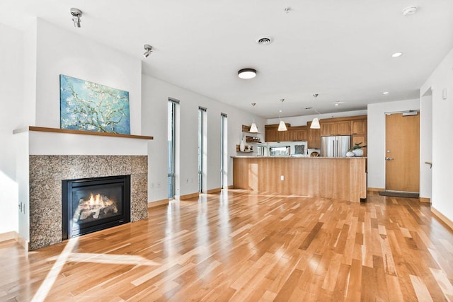 unfurnished living room featuring light hardwood / wood-style floors