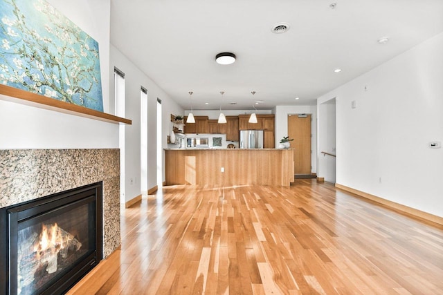 unfurnished living room with light hardwood / wood-style floors