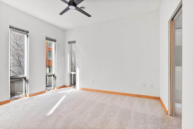 unfurnished bedroom with ceiling fan and light carpet