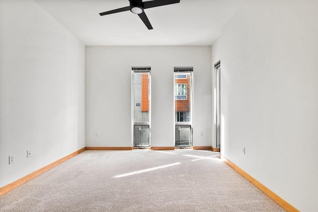 unfurnished room with ceiling fan and carpet flooring