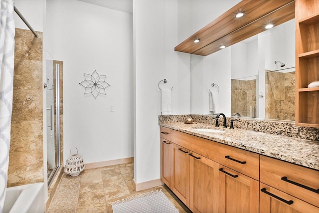 bathroom with vanity and tiled shower