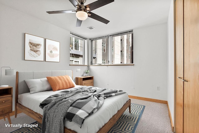 bedroom with ceiling fan and light carpet