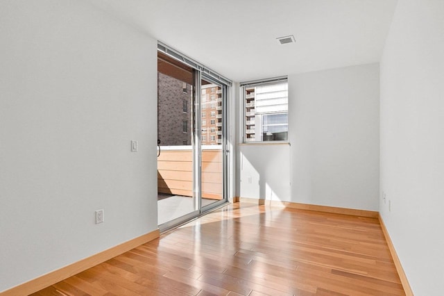 spare room with hardwood / wood-style floors