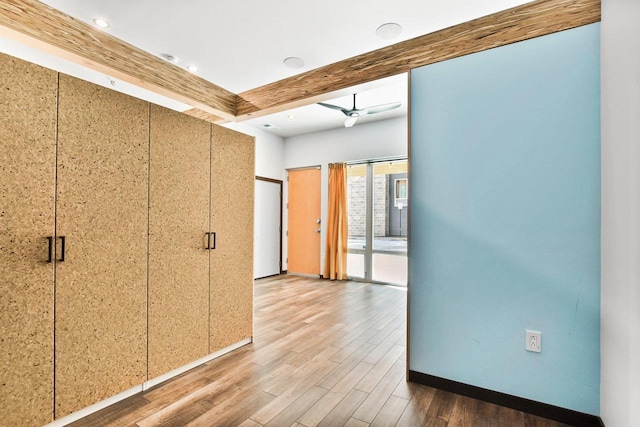 corridor with beam ceiling and wood-type flooring