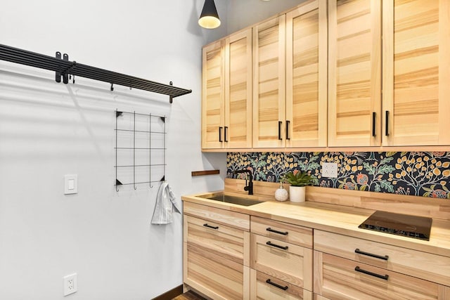 kitchen with butcher block countertops, sink, and light brown cabinets