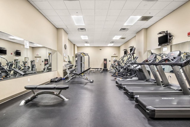 gym with a paneled ceiling