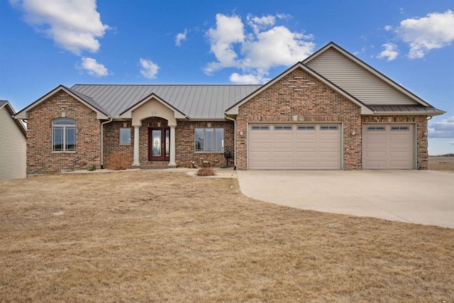 view of front of property with a garage and a front lawn