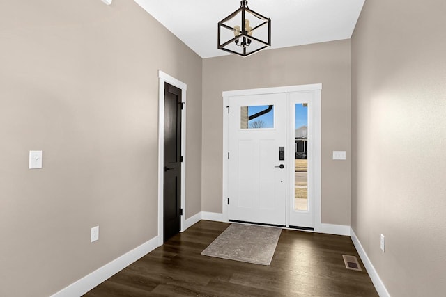 entryway featuring dark hardwood / wood-style floors and a chandelier