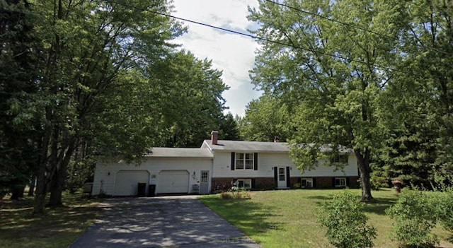 view of front facade with a garage and a front lawn