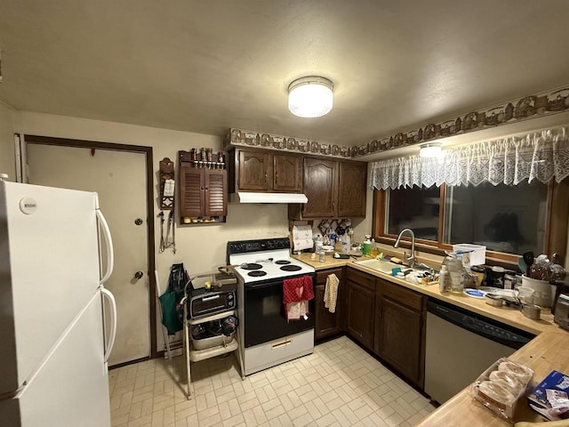 kitchen featuring sink, white appliances, and dark brown cabinets