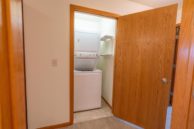 laundry area with light colored carpet and stacked washing maching and dryer