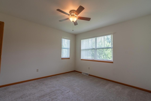 carpeted empty room featuring ceiling fan