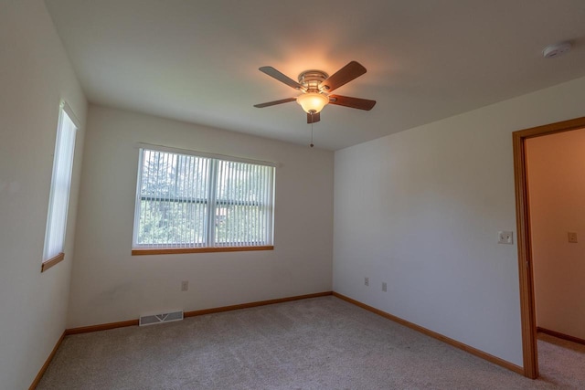 empty room with light colored carpet and ceiling fan