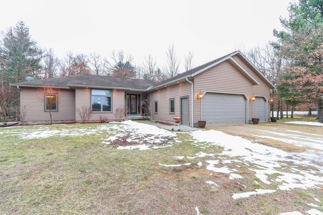 single story home with a garage and a front lawn