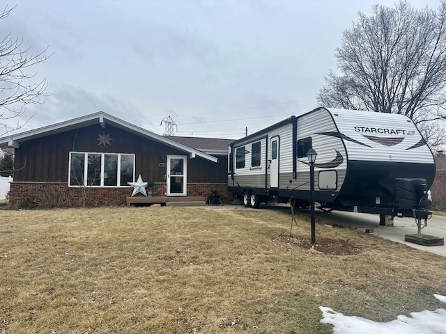 view of side of home with a lawn