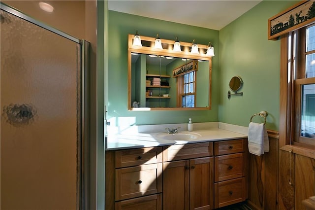 bathroom featuring vanity and a shower with shower door