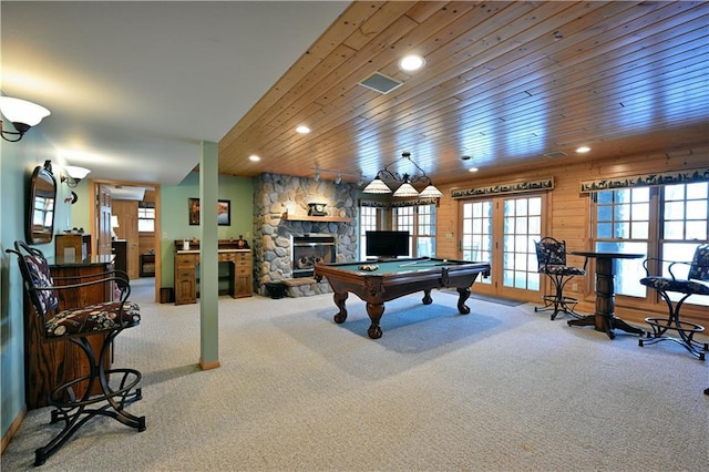 game room with a fireplace, wooden ceiling, french doors, and carpet