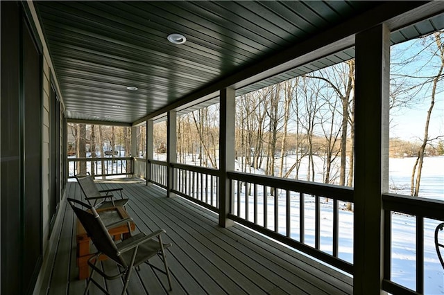 snow covered deck with a water view