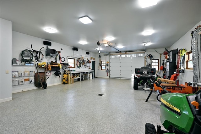 garage featuring a garage door opener and a workshop area