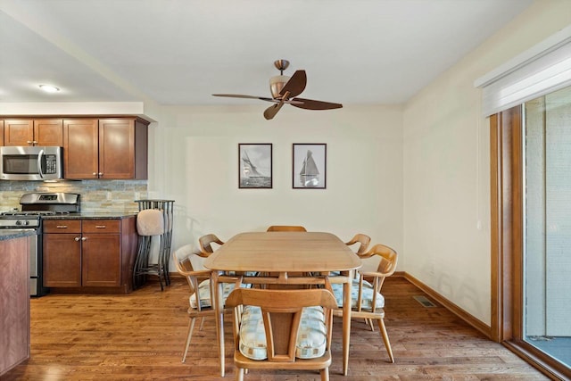 dining room with wood-type flooring and ceiling fan